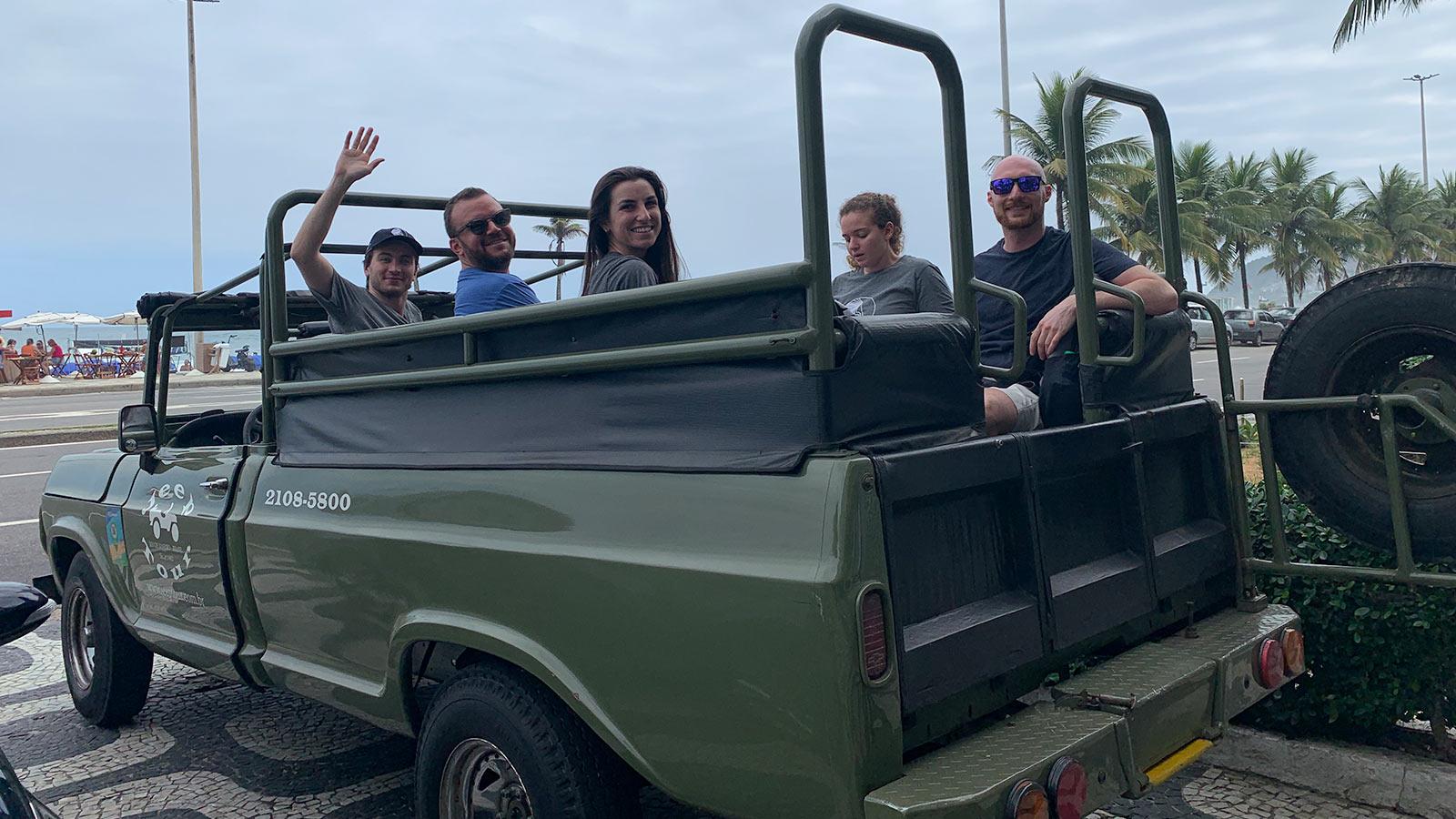 Group of Elisabeth Haub School of Law students in the back of a Jeep near a beach in Brazil
