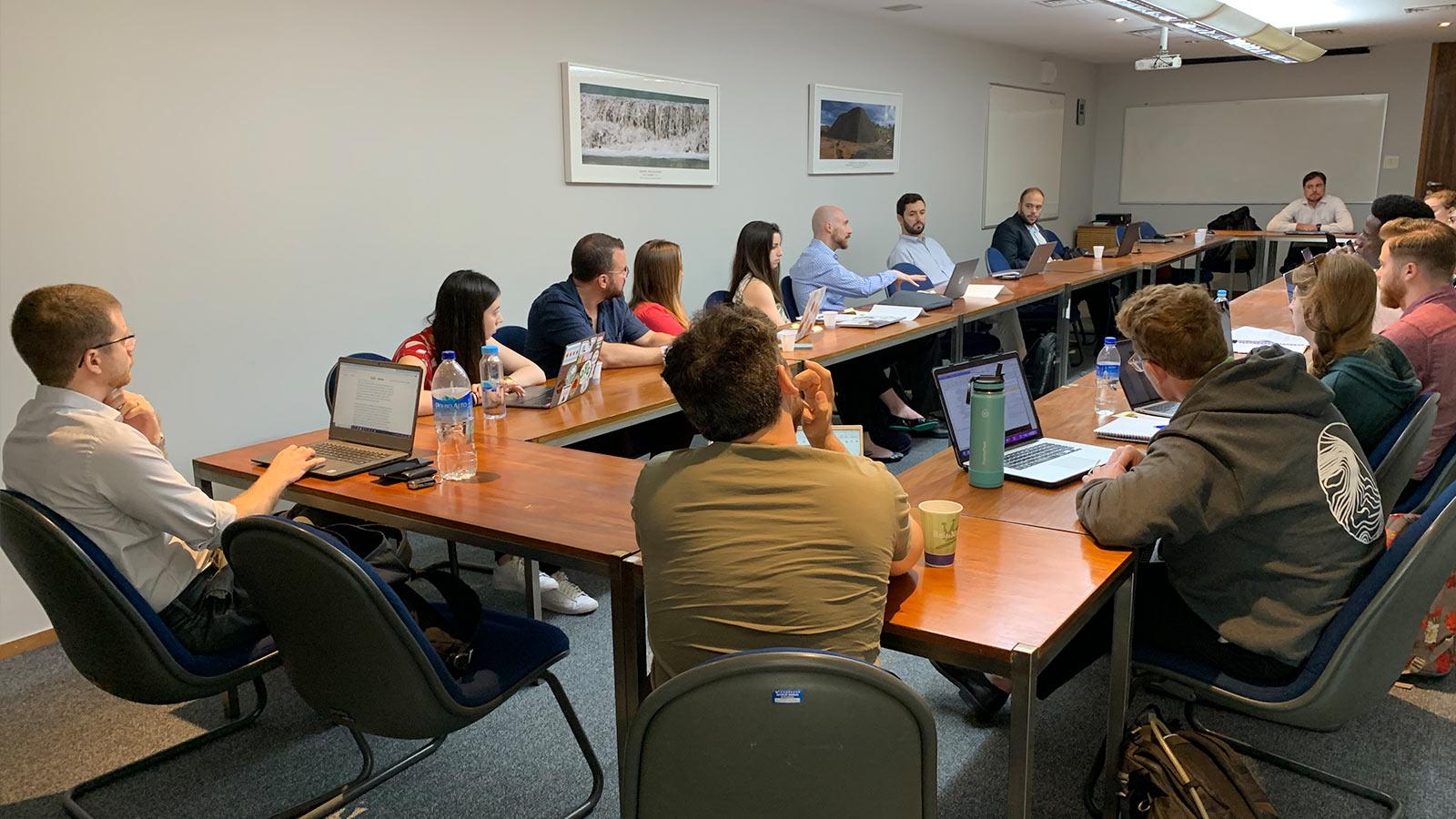 Group of Elisabeth Haub School of Law students sitting around a table