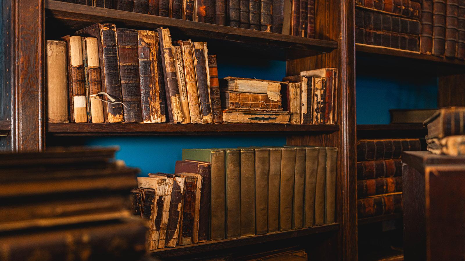 antique books on shelves inside the Pace Study