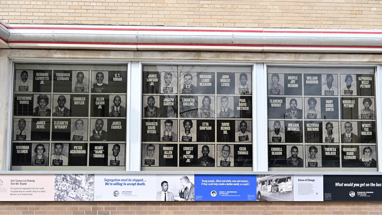window display of black and white photos with names of Freedom Riders. 