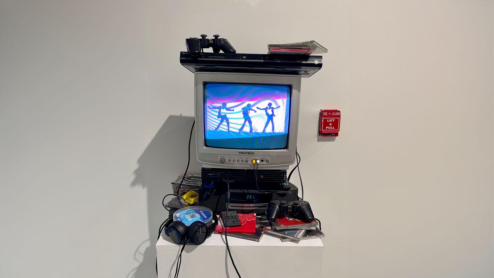 Television artwork called Chartreusetaxi by student Jordan Cann on display in the Corporate Holiday Party: Senior Capstone Exhibition in the Pace University Art Gallery.