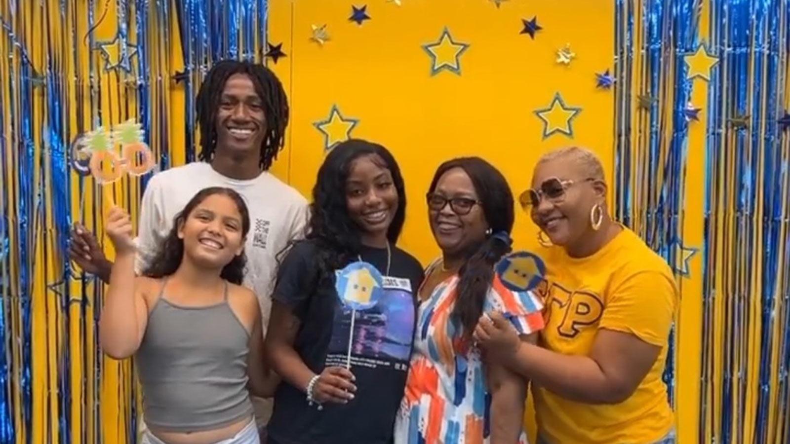 Pace University students posing in front of blue and gold streamers