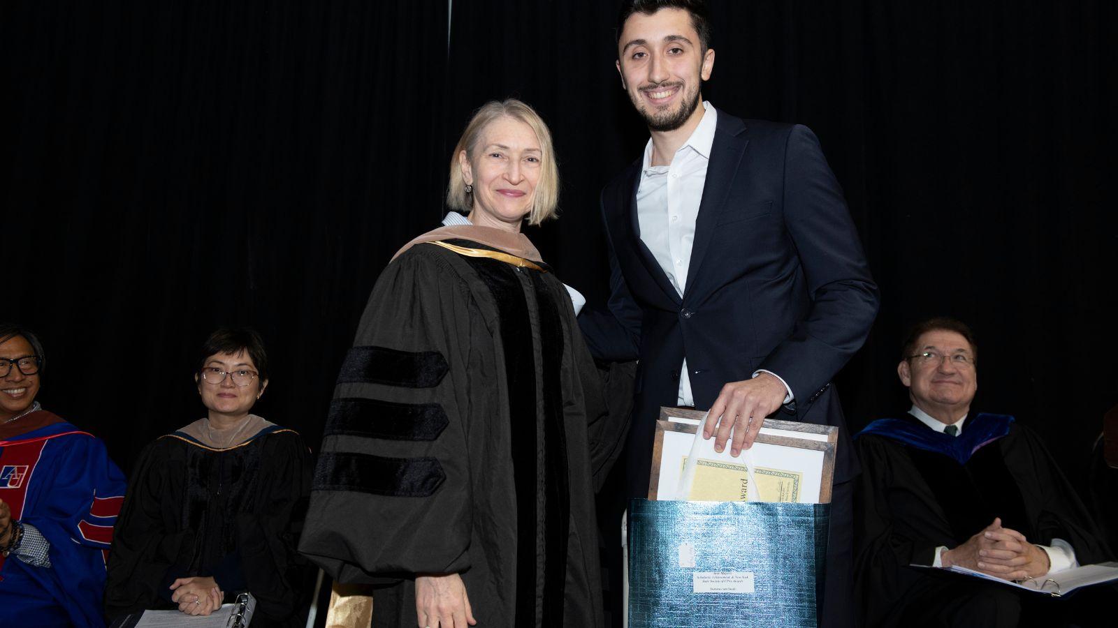 Dr. Randi Priluck congratulating Amir Mujovic, recipient of the Scholastic Achievement Award.