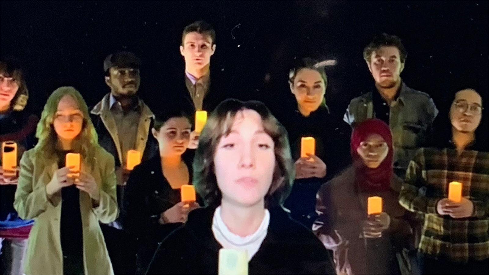 Students from the Sands College of Performing Arts holding candles