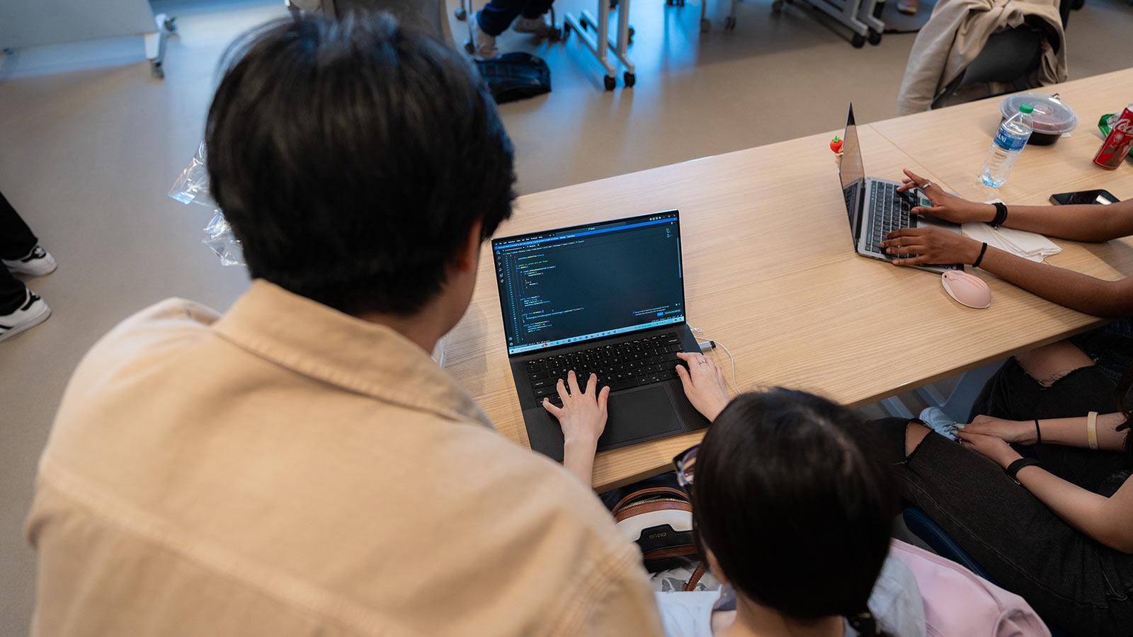 Pace students play a student game on a laptop