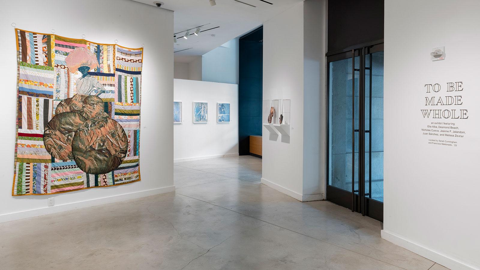 Artwork from various artists on display in the "To Be Made Whole" exhibition at the Pace University Art Gallery.