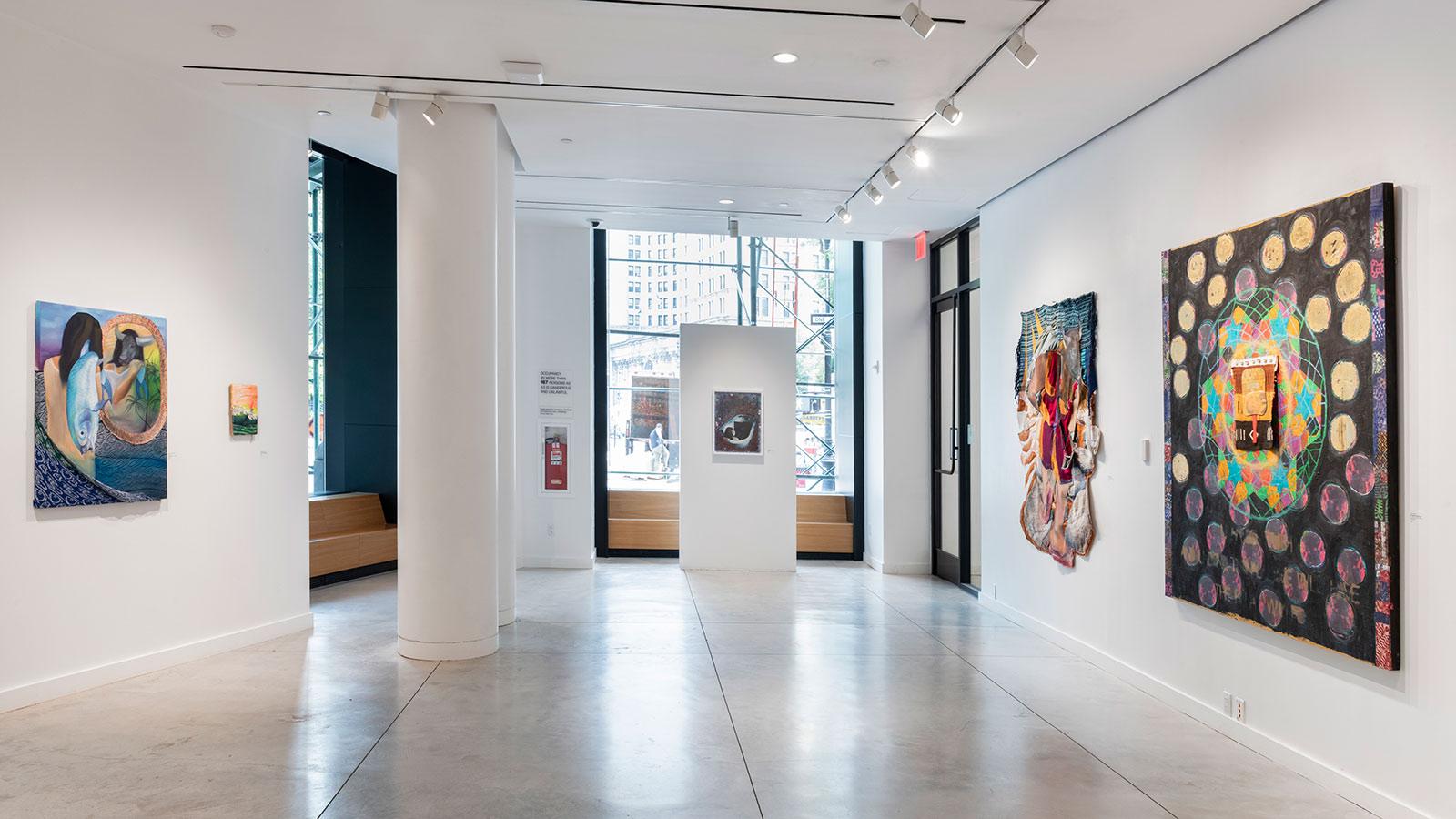 Artwork from various artists on display in the "To Be Made Whole" exhibition at the Pace University Art Gallery.