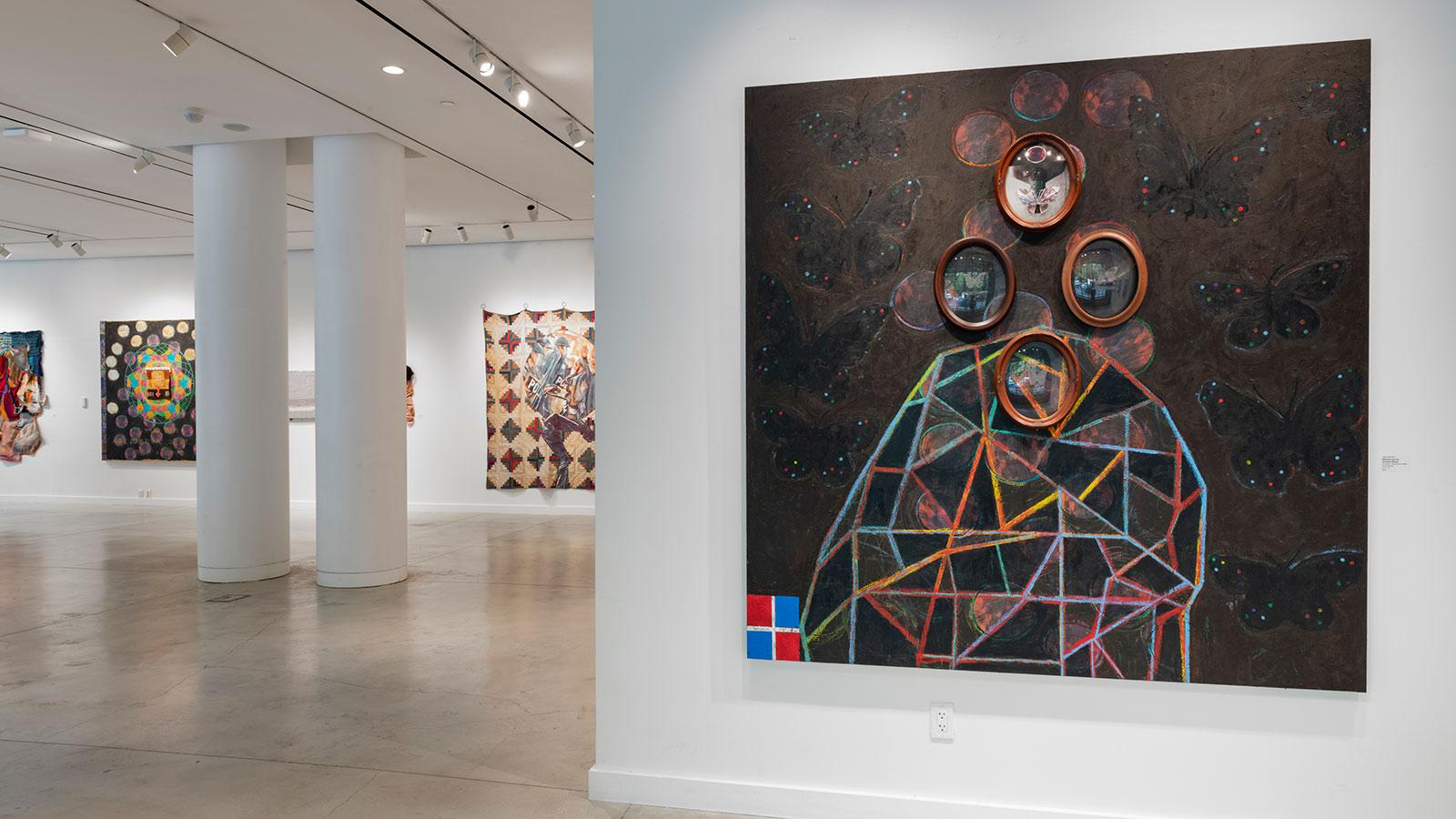 Artwork from various artists on display in the "To Be Made Whole" exhibition at the Pace University Art Gallery.