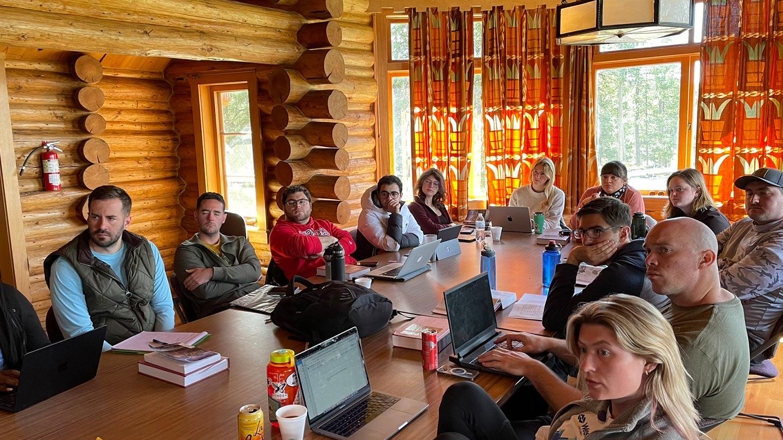 Elisabeth Haub School of Law students collaborating in log cabin setting