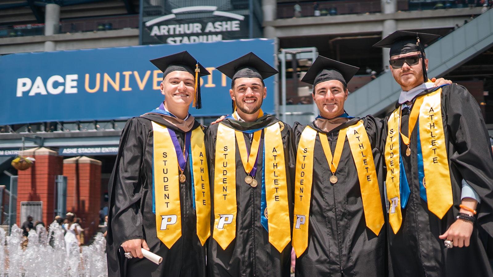 Pace grads posing at Commencement. 