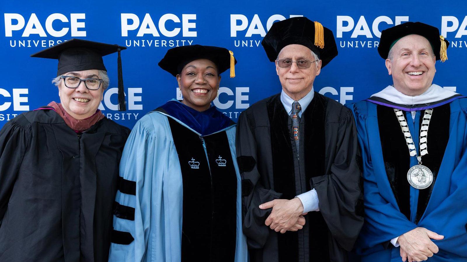 Manuela Soares, Dean Tresmaine Grimes, Paul Levitz, and Marvin Krislov posing for the camera. 