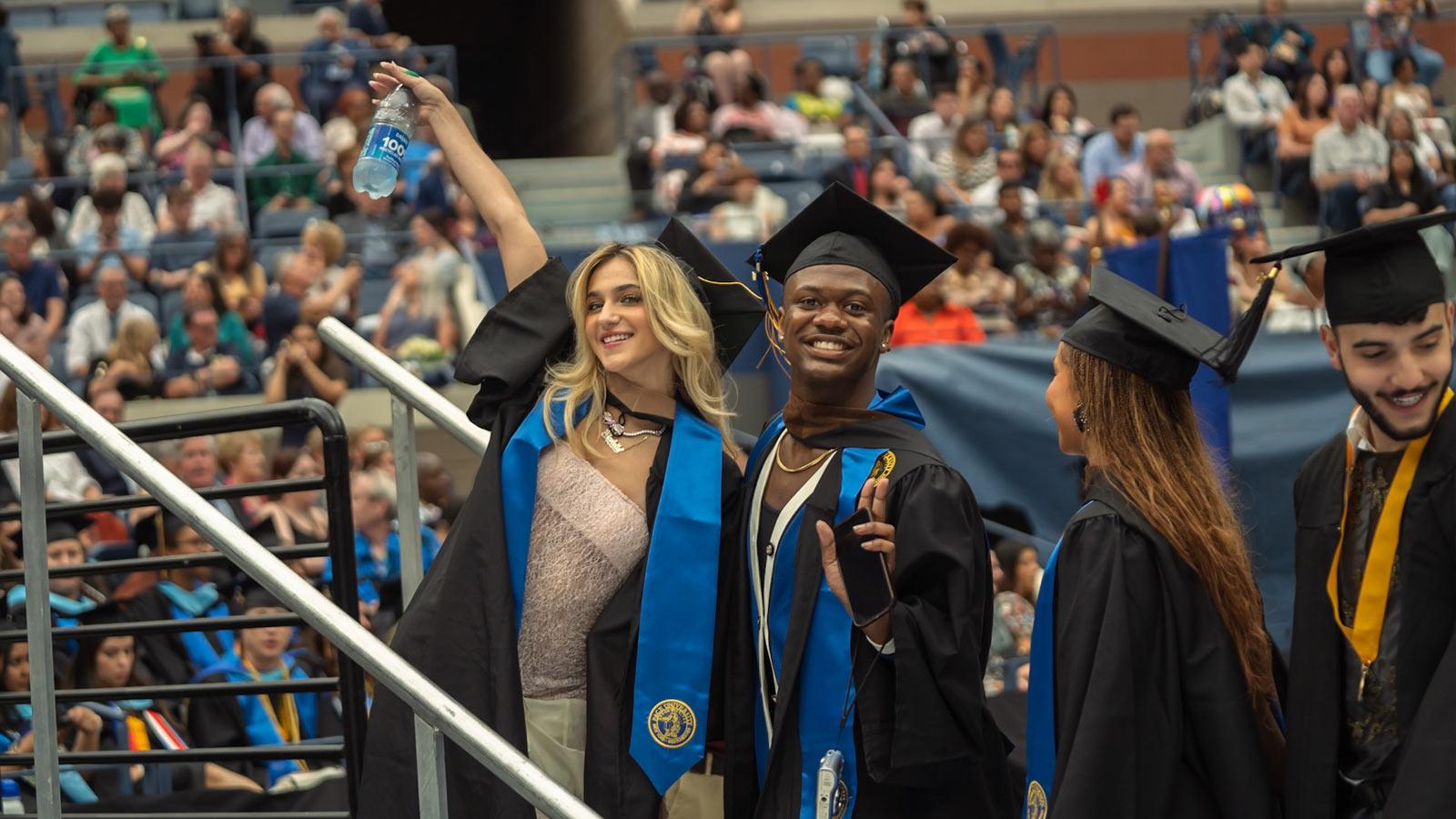Pace grads posing at Commencement. 