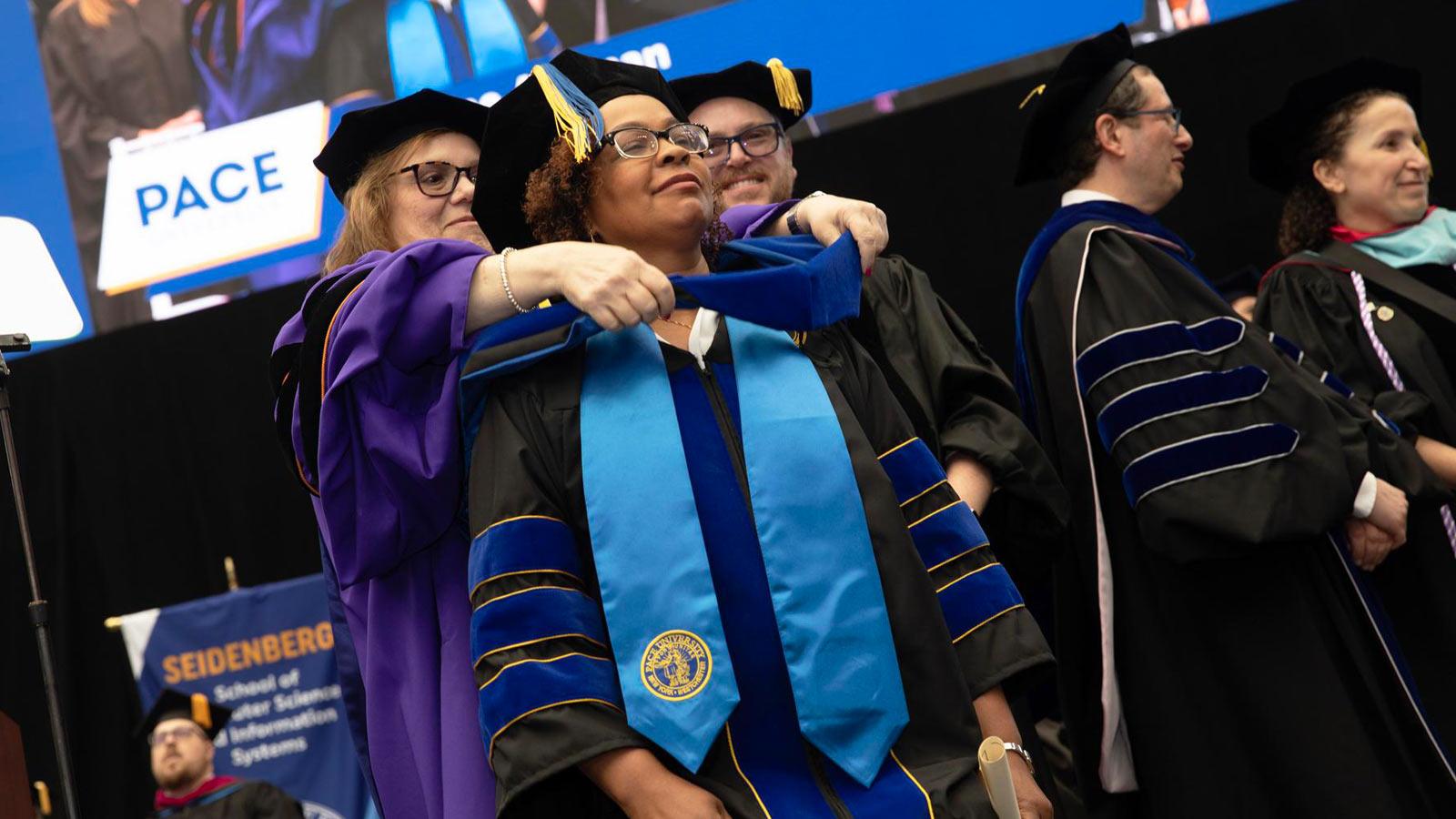 Pace grad posing at Commencement. 