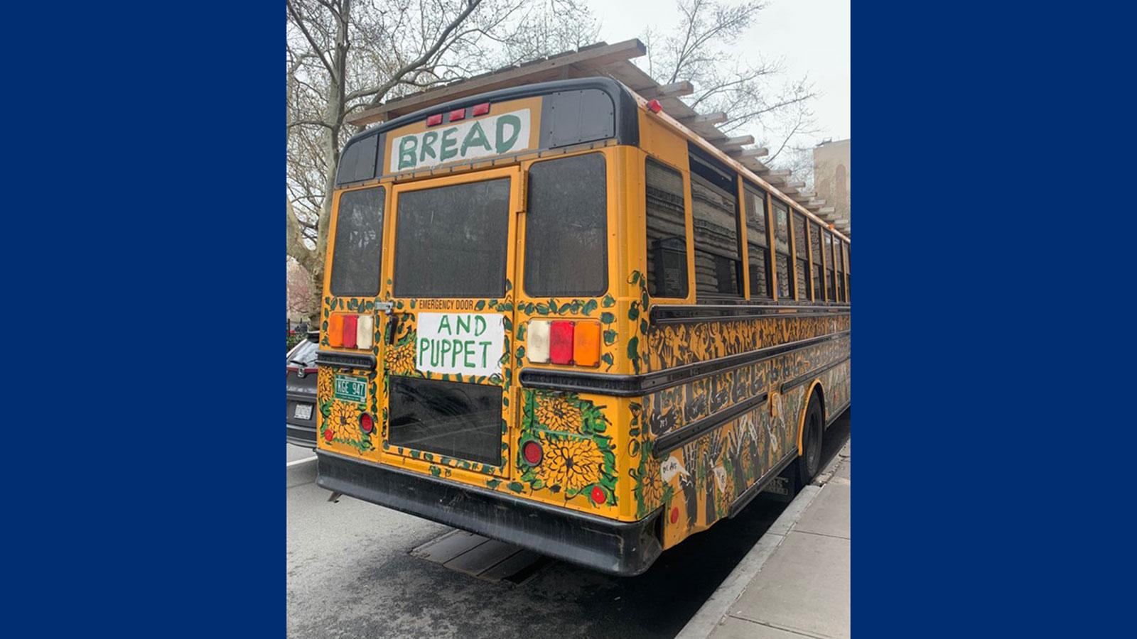 The Bread and Puppet Theater bus, covered in artwork. The Bread and Puppet Theater worked with Peace and Justice Studies and English students to express social justice through art.