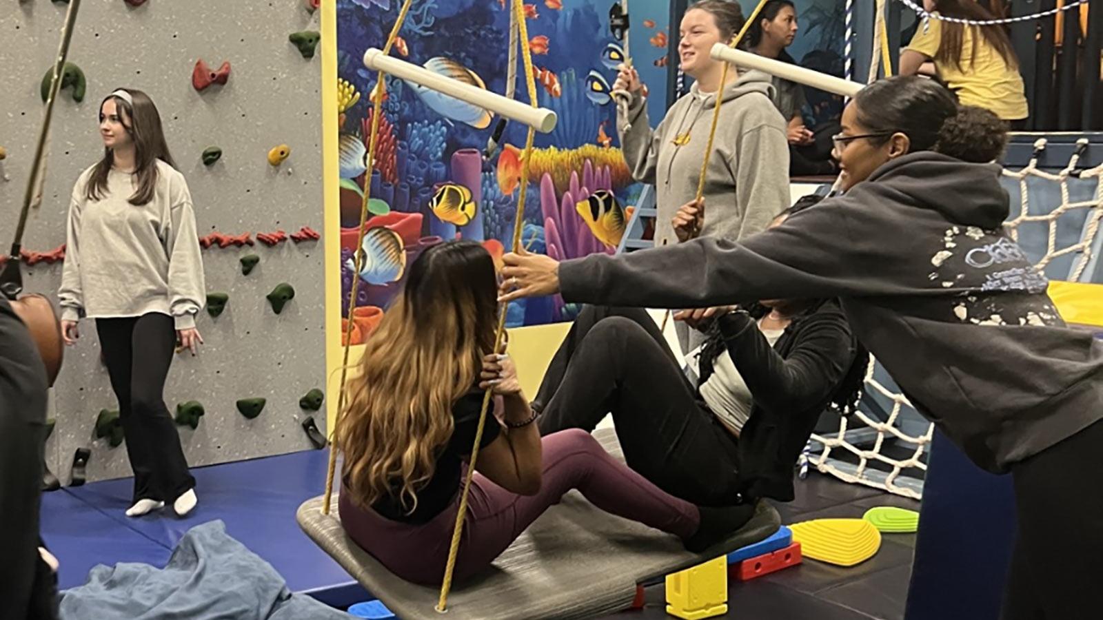 2025 Occupational Therapy students at Pace University exploring swings and rock climbing walls.