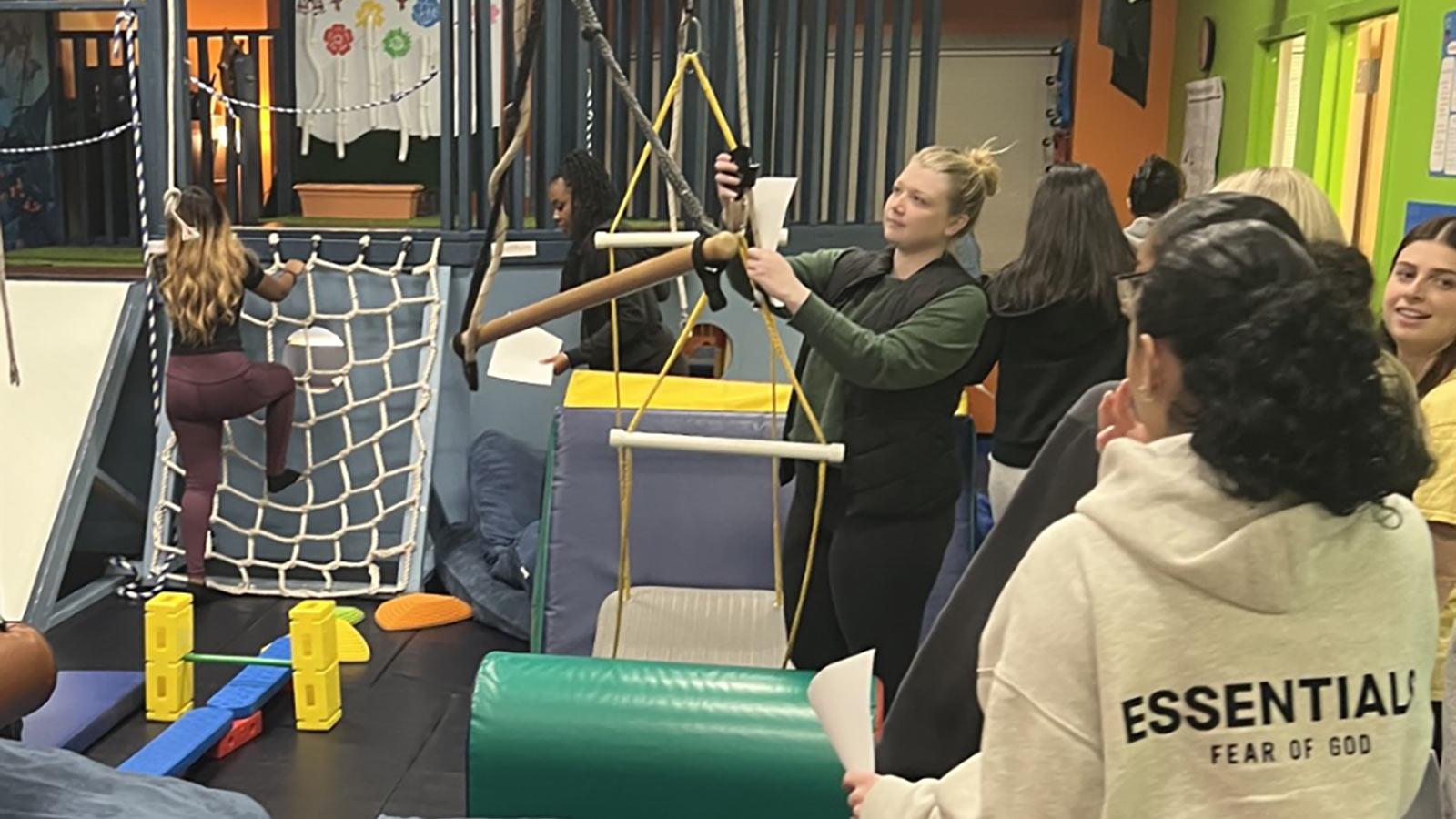 2025 Occupational Therapy students at Pace University learning how to use swings in play area.