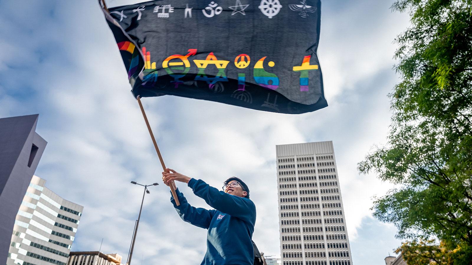 Photo by Josh Pacheco of a person waving a flag at the Blasian March in Los Angeles
