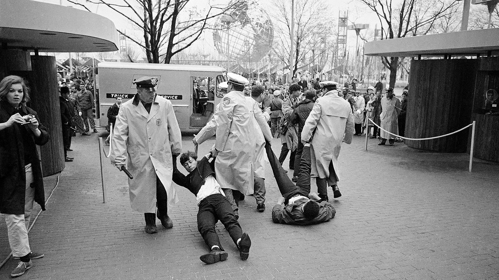 Private fair police drag two civil demonstrators from the New York State pavilion at the New York World’s Fair on April 22, 1964 after demonstrators blocked at least one entrance to the building.