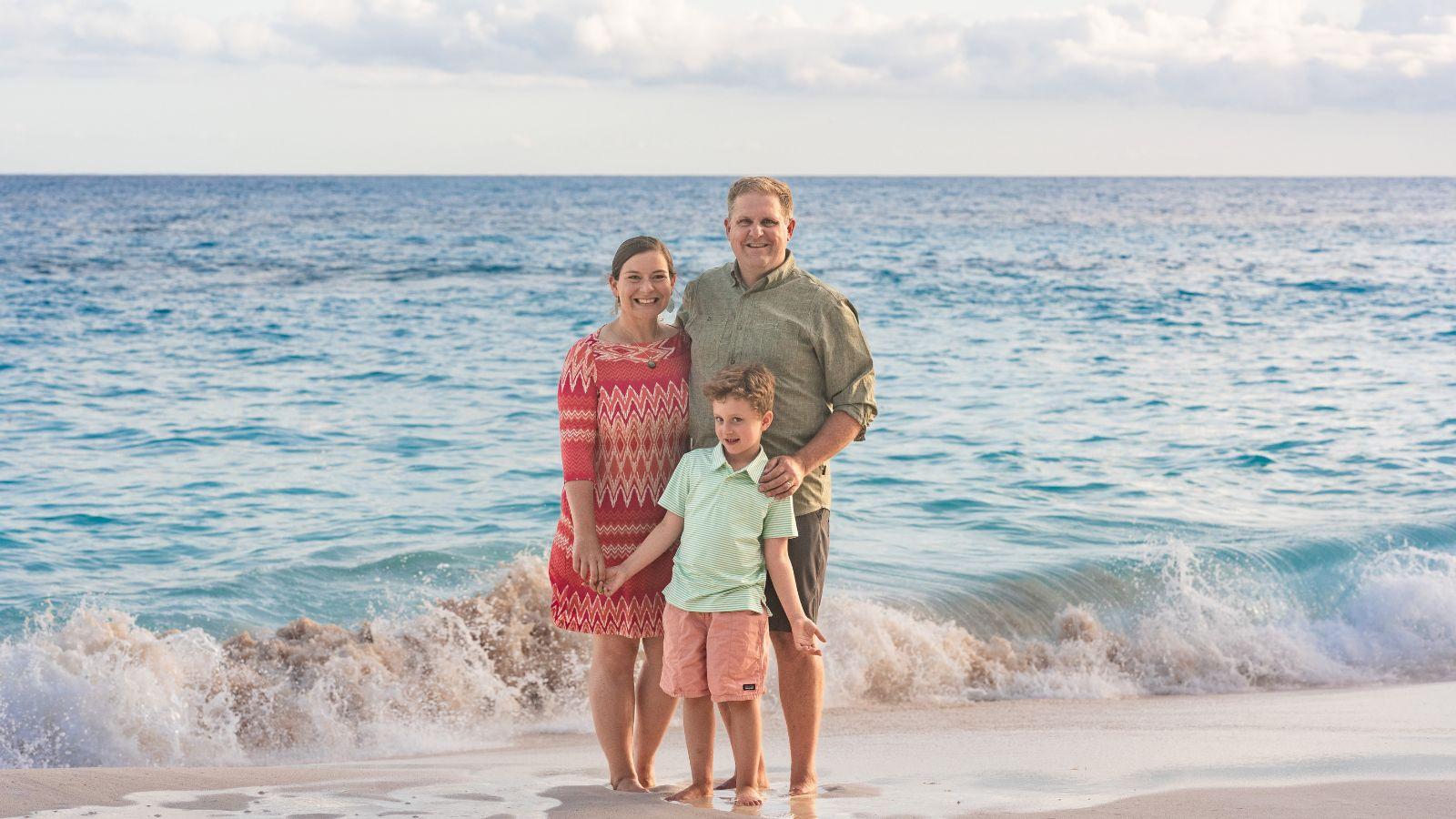 Elisabeth Haub School of Law at Pace University 2009 alumni Erin and Brent Keith pictured with their son on a beach