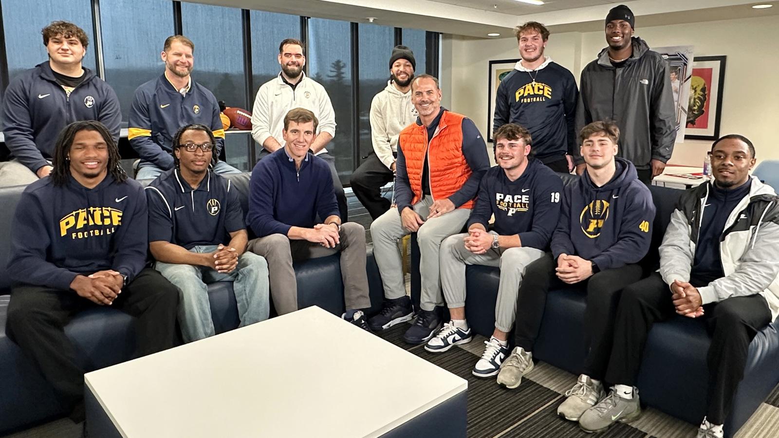 Pace football team posing with Jalen Brunson, Eli Manning, and Shaun O'Hara