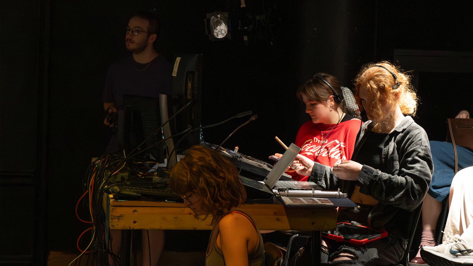 Crew of The Seagull working with props on the table.