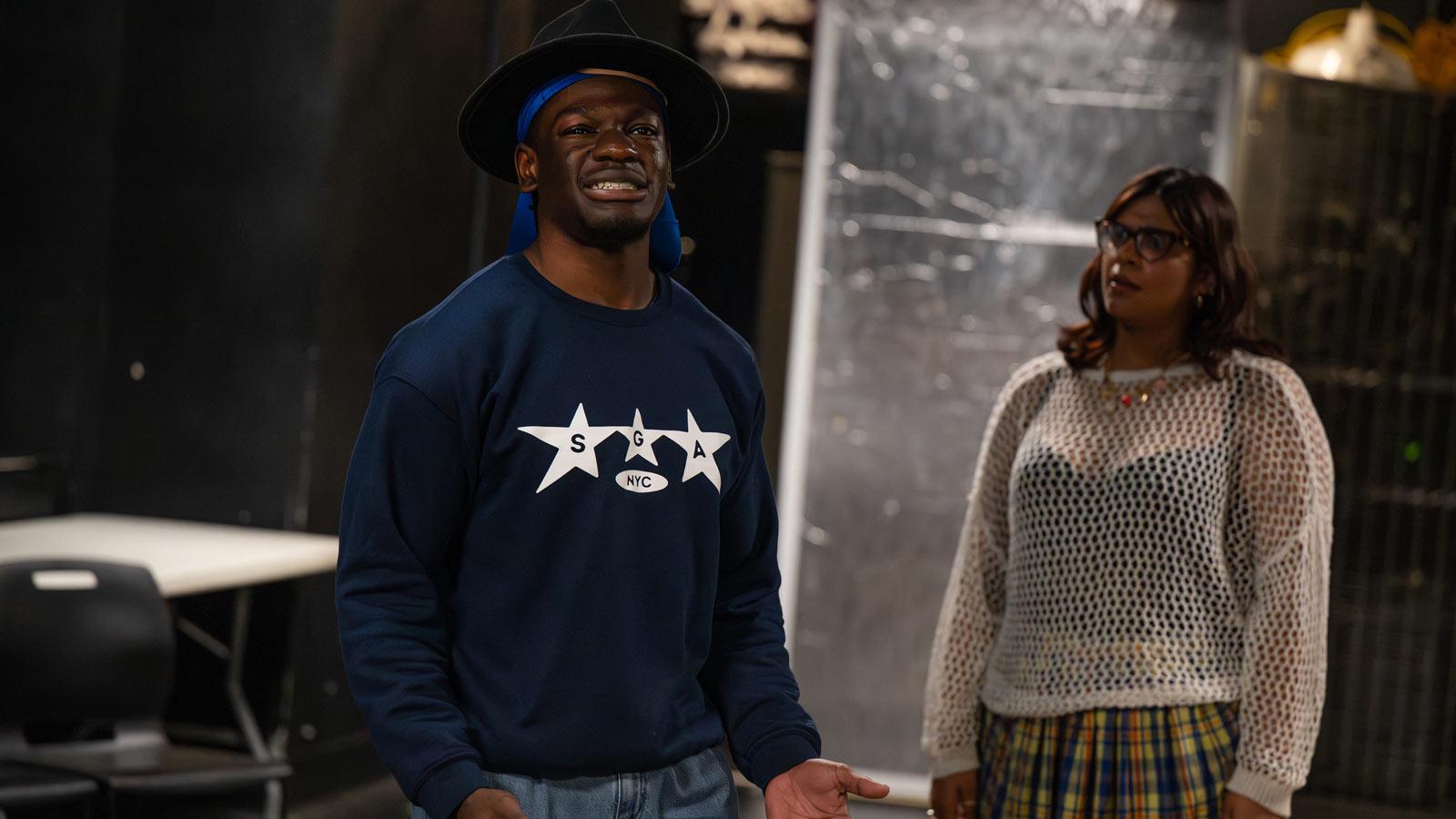 Students rehearsing on stage.