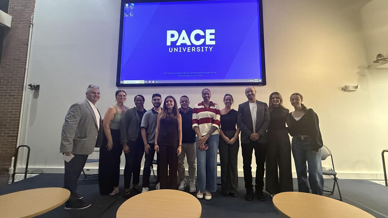 Leigh Klein posing with students at the Pace University Sports Business Career Night.