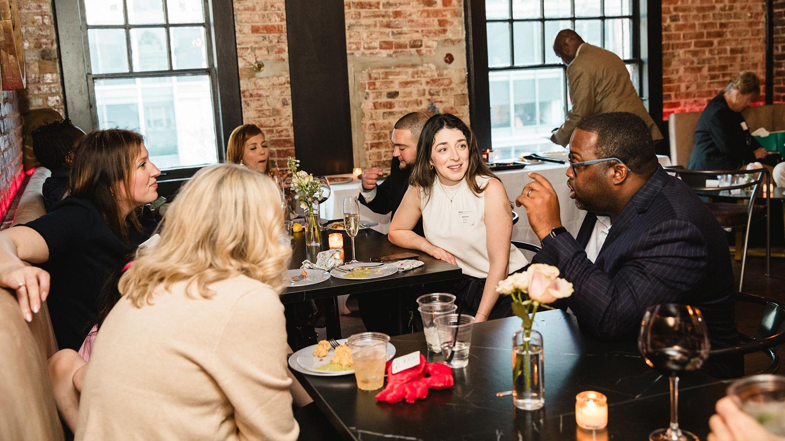 Pace University alumni sitting at a table at the D.C. Regional Alumni Event.