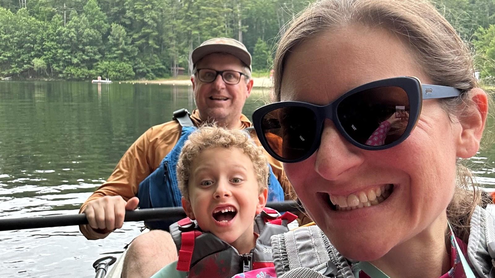 Elisabeth Haub School of Law 2009 alumni in a boat with their child