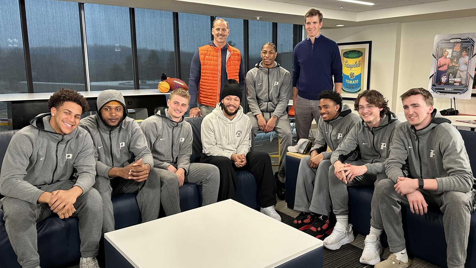Pace men's basketball team posing with Jalen Brunson, Eli Manning, and Shaun O'Hara