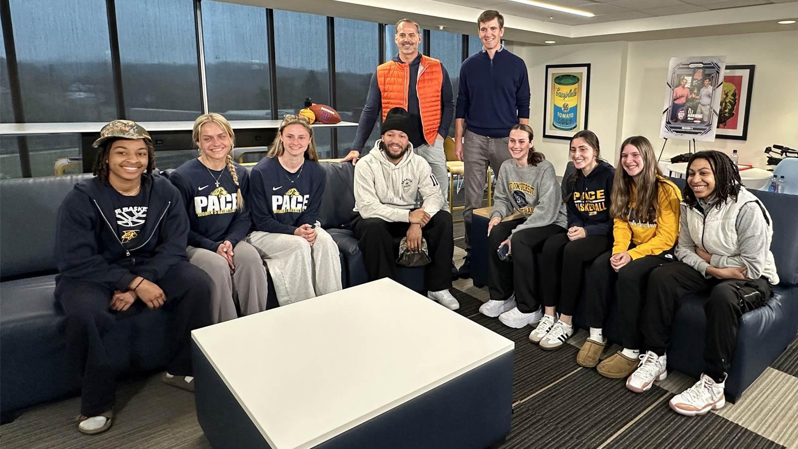 Pace women's basketball team posing with Jalen Brunson, Eli Manning, and Shaun O'Hara