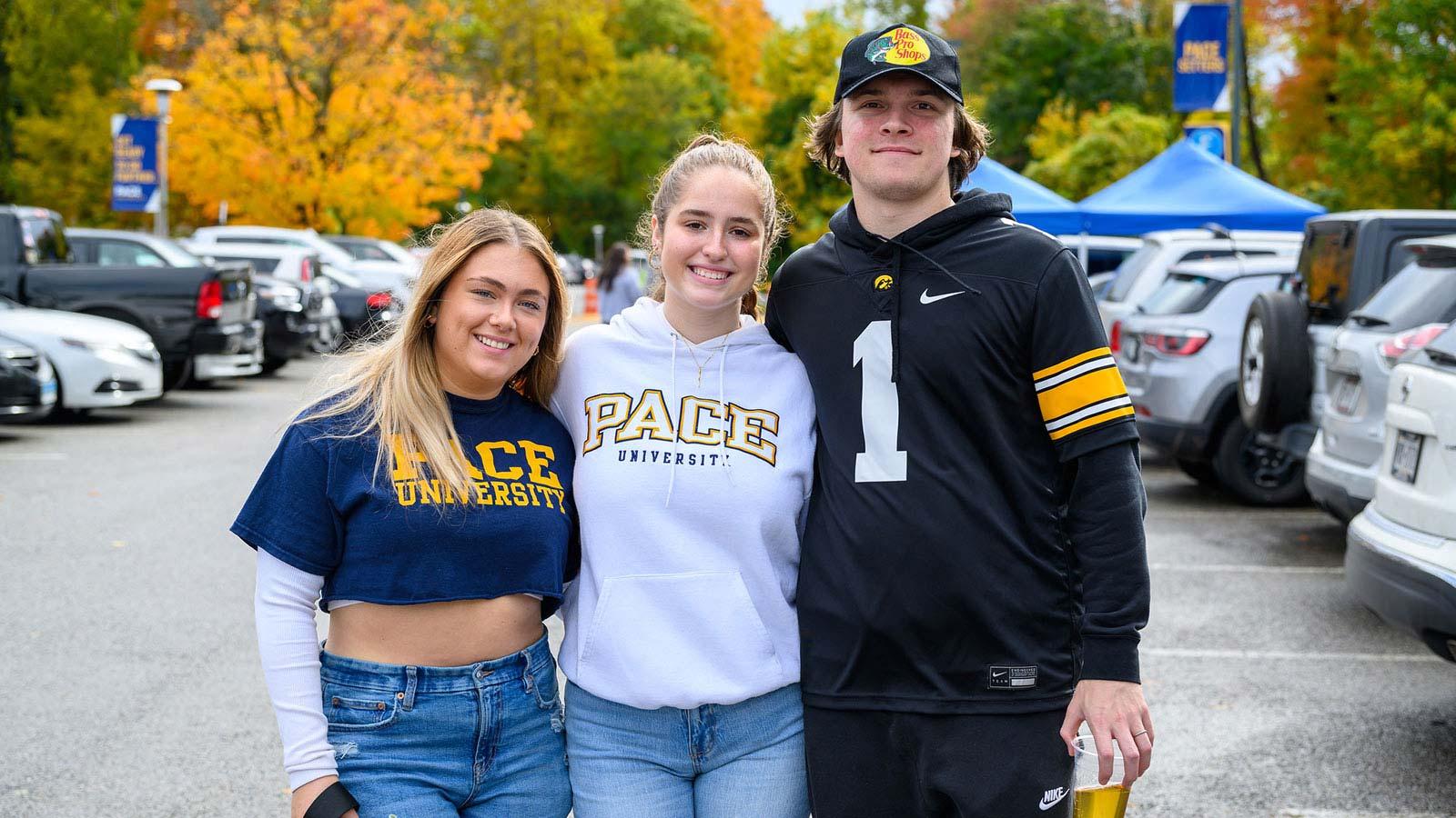 Group shot of Pace University student smiling at the camera at Homecoming.
