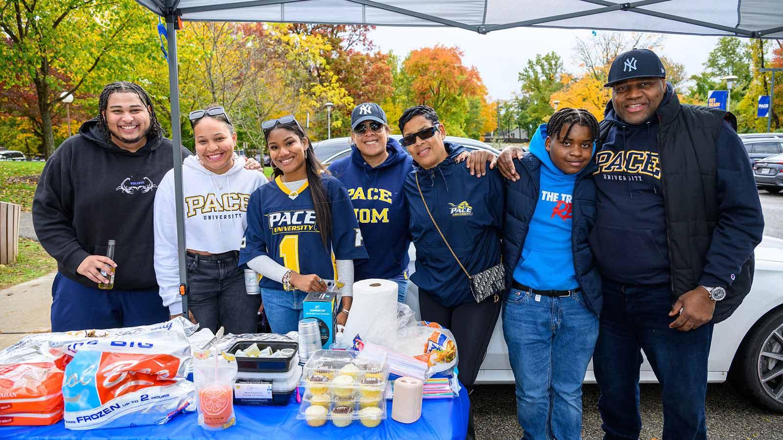 Group shot of Pace University student smiling at the camera at Homecoming.