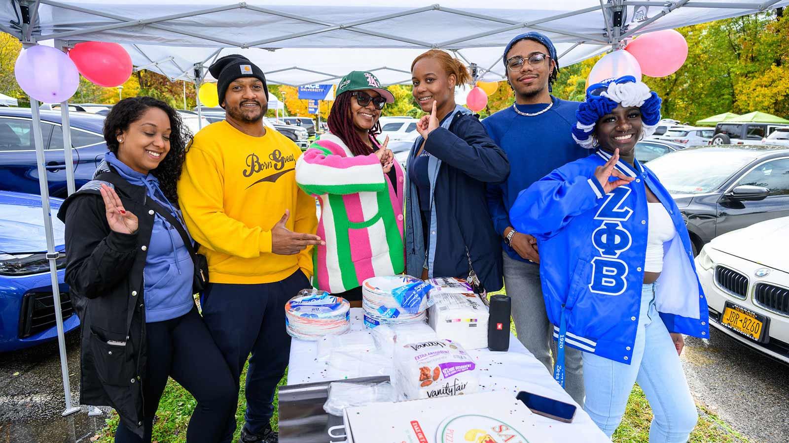 Group shot of Pace University student smiling at the camera at Homecoming.