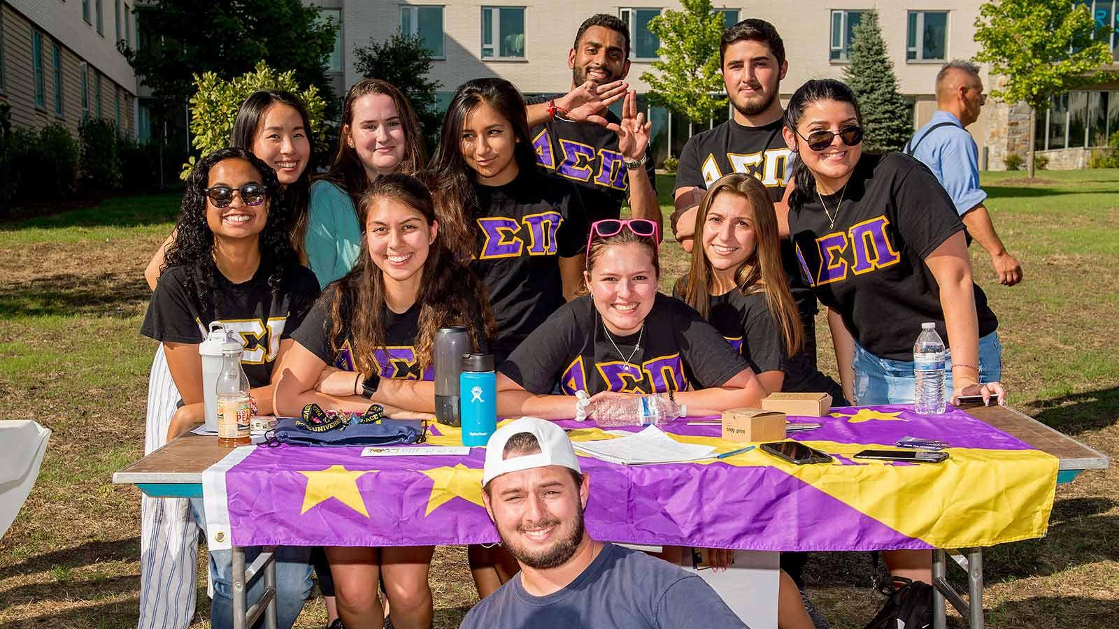 Group of Pace University students who are part of greek life, smiling at the camera.