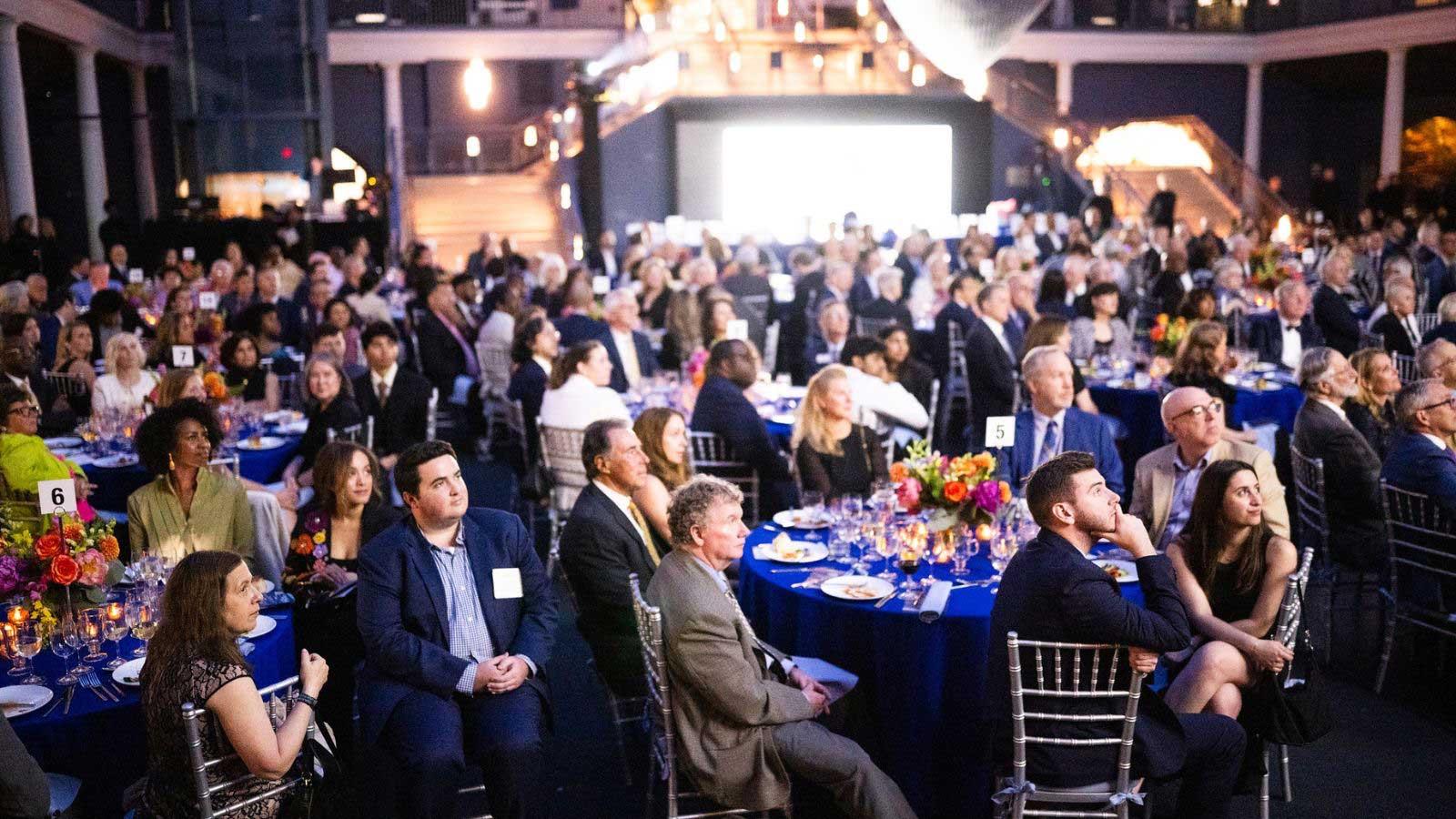 Guests look up at a screen during the 2026 Spirit of Pace Awards dinner.