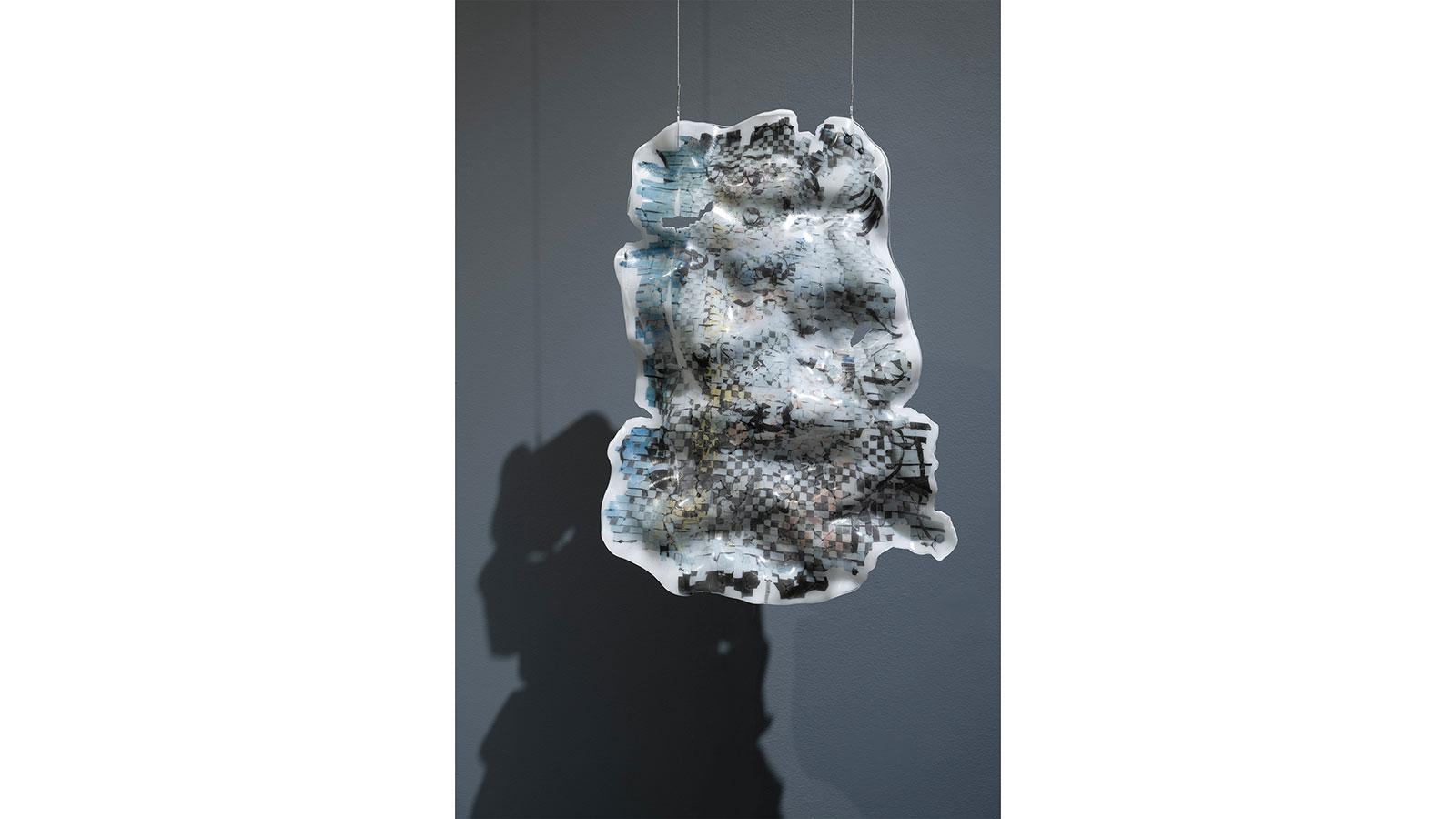 Abstract art piece of a coffin filled with artificial flowers and studio light by Juyon Lee