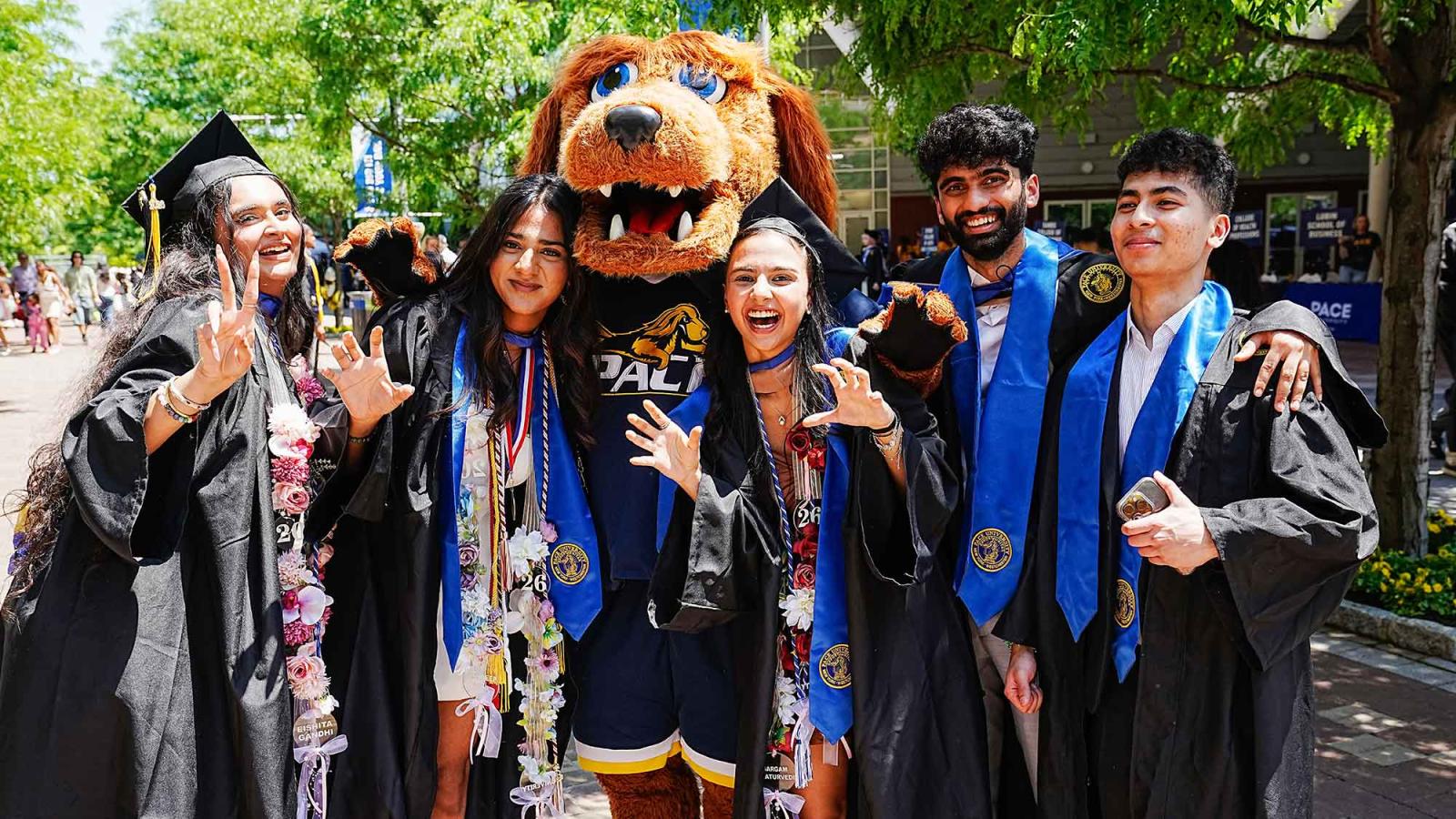 Pace University's mascot T-Bone poses with new graduates