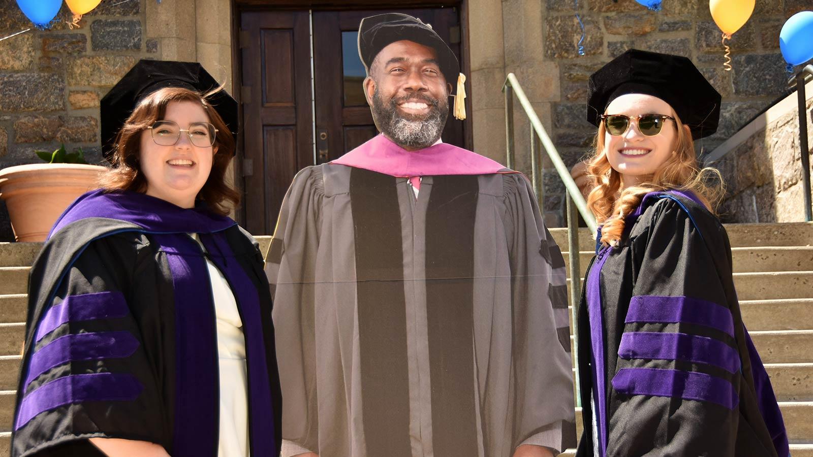 Pace Haub Law students posing with a cutout of Dean Anderson.