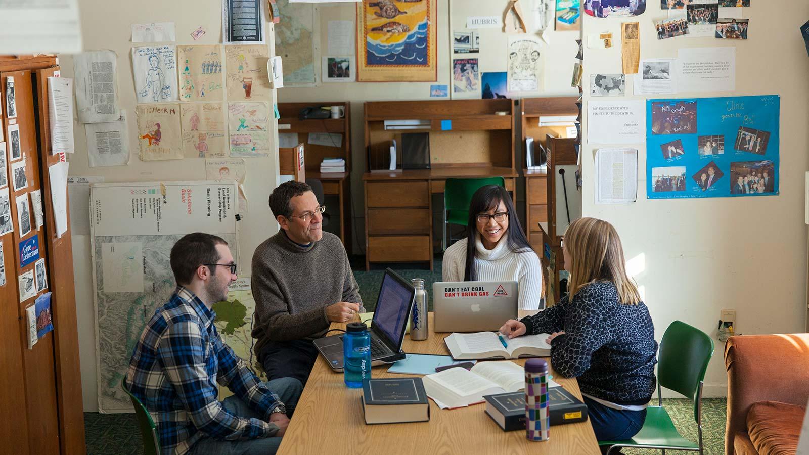 Pace Haub Law faculty and students sitting around a table.