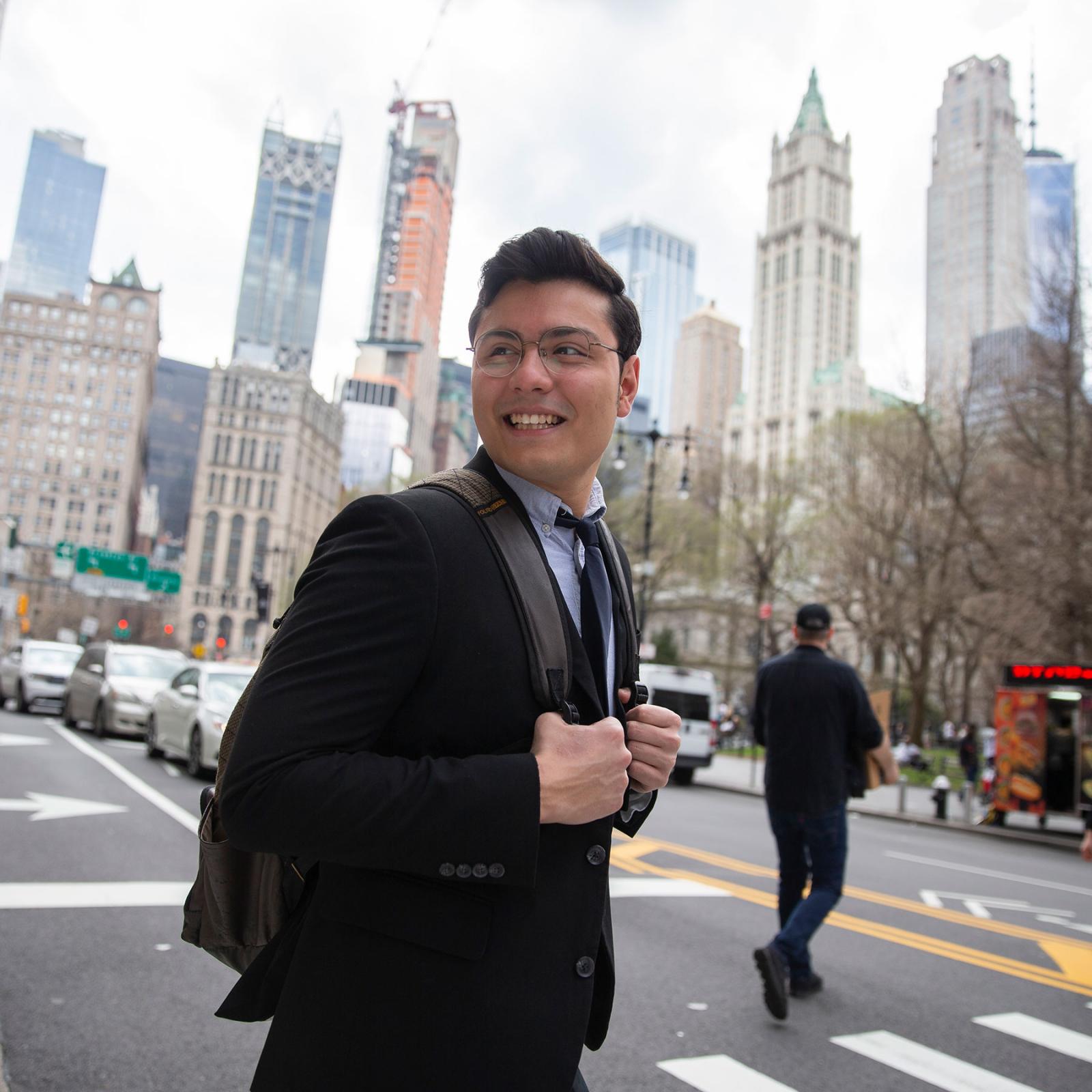 Student dressed in a suit walking around NYC.