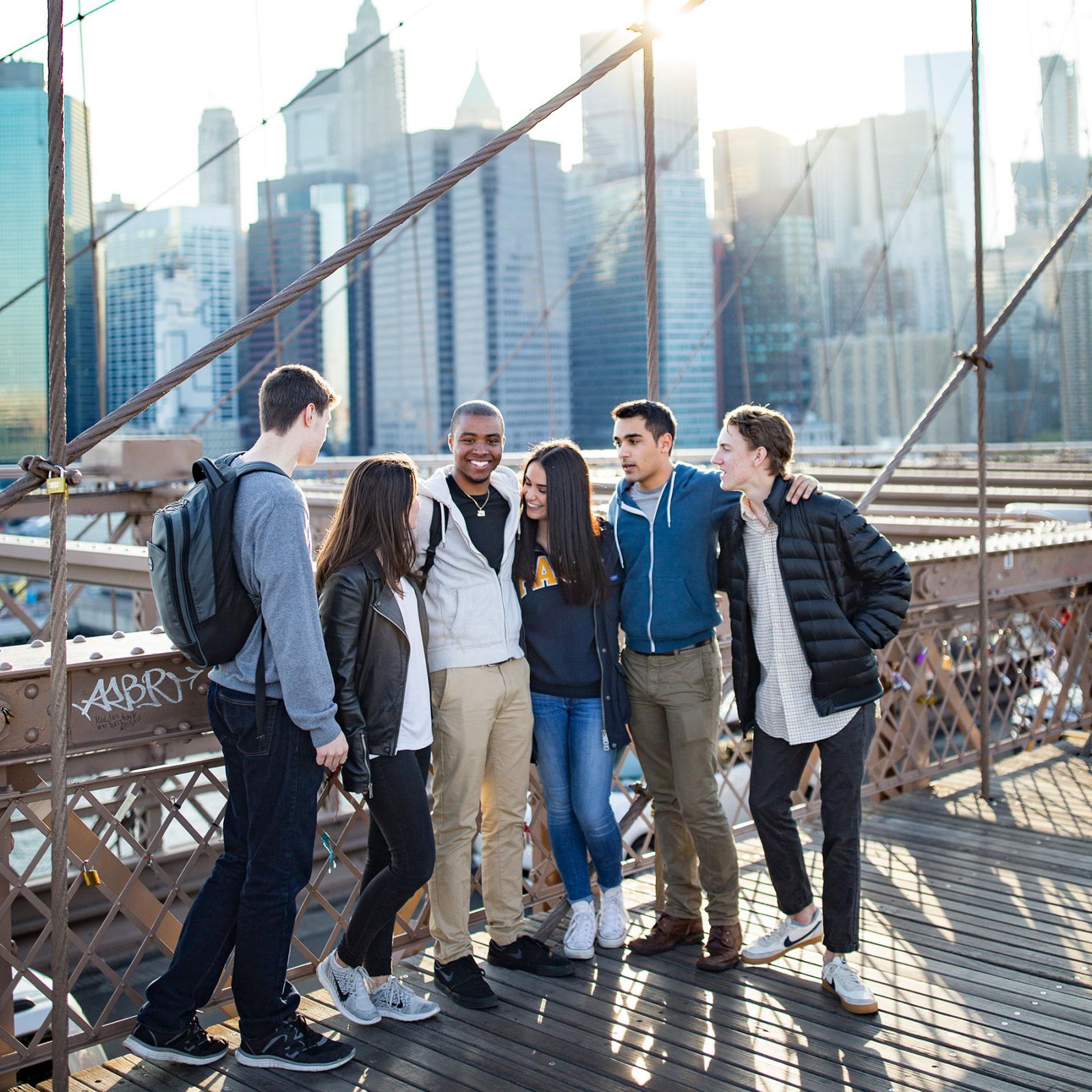 Pace University students standing on the Brooklyn Bridge