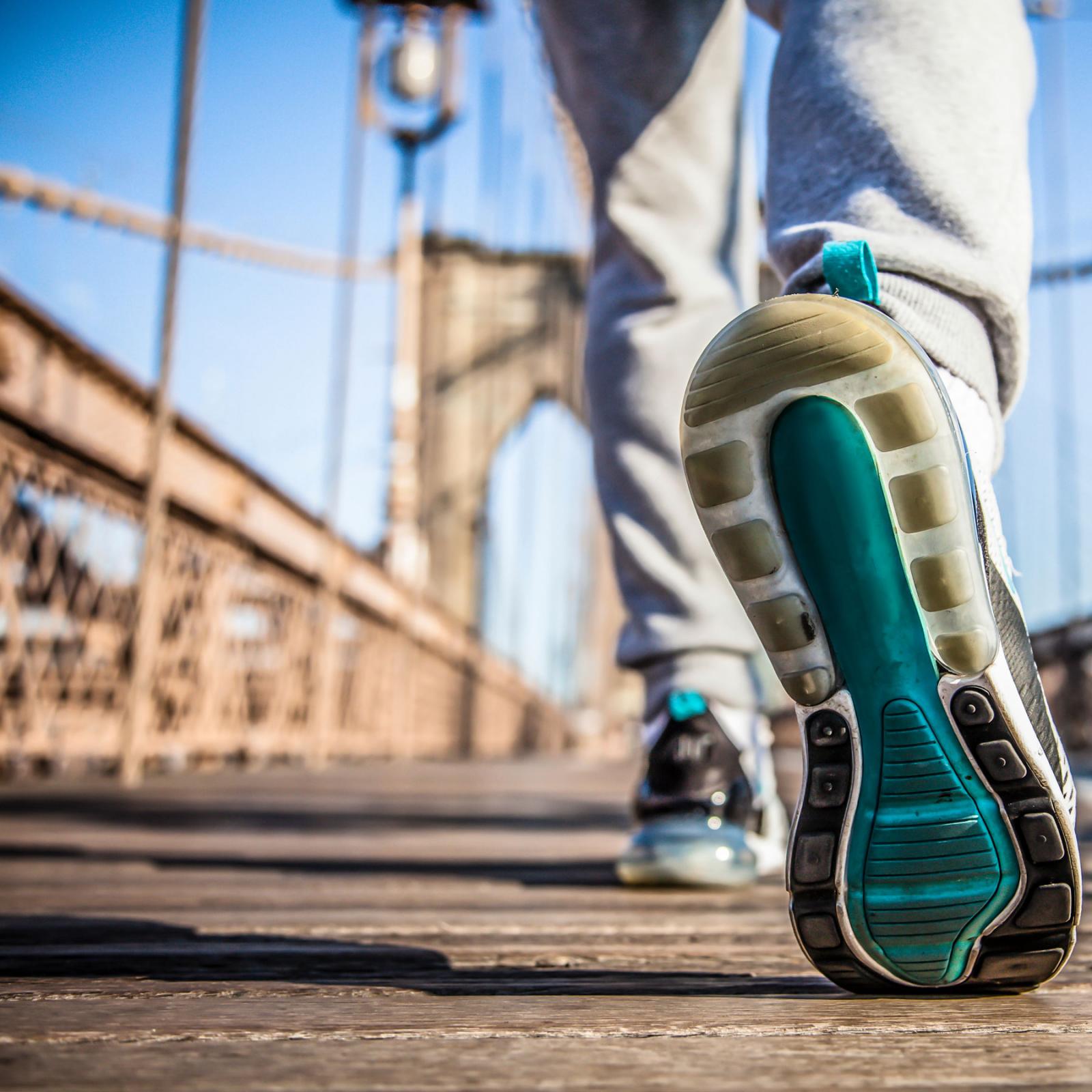 Person walking accross the Brooklyn Bridge.