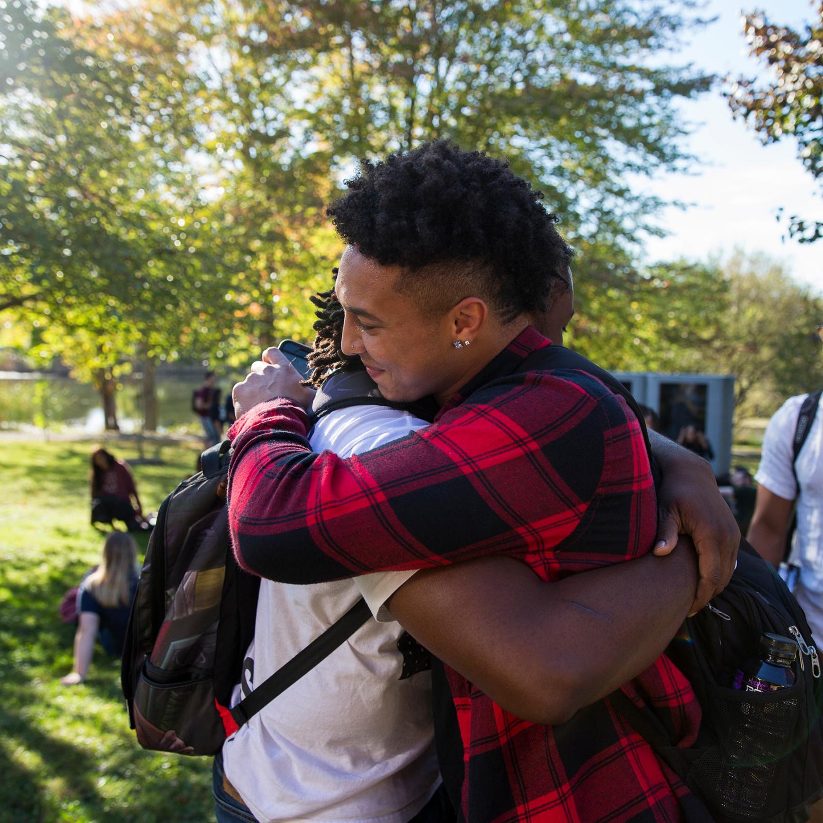 Two students hugging.