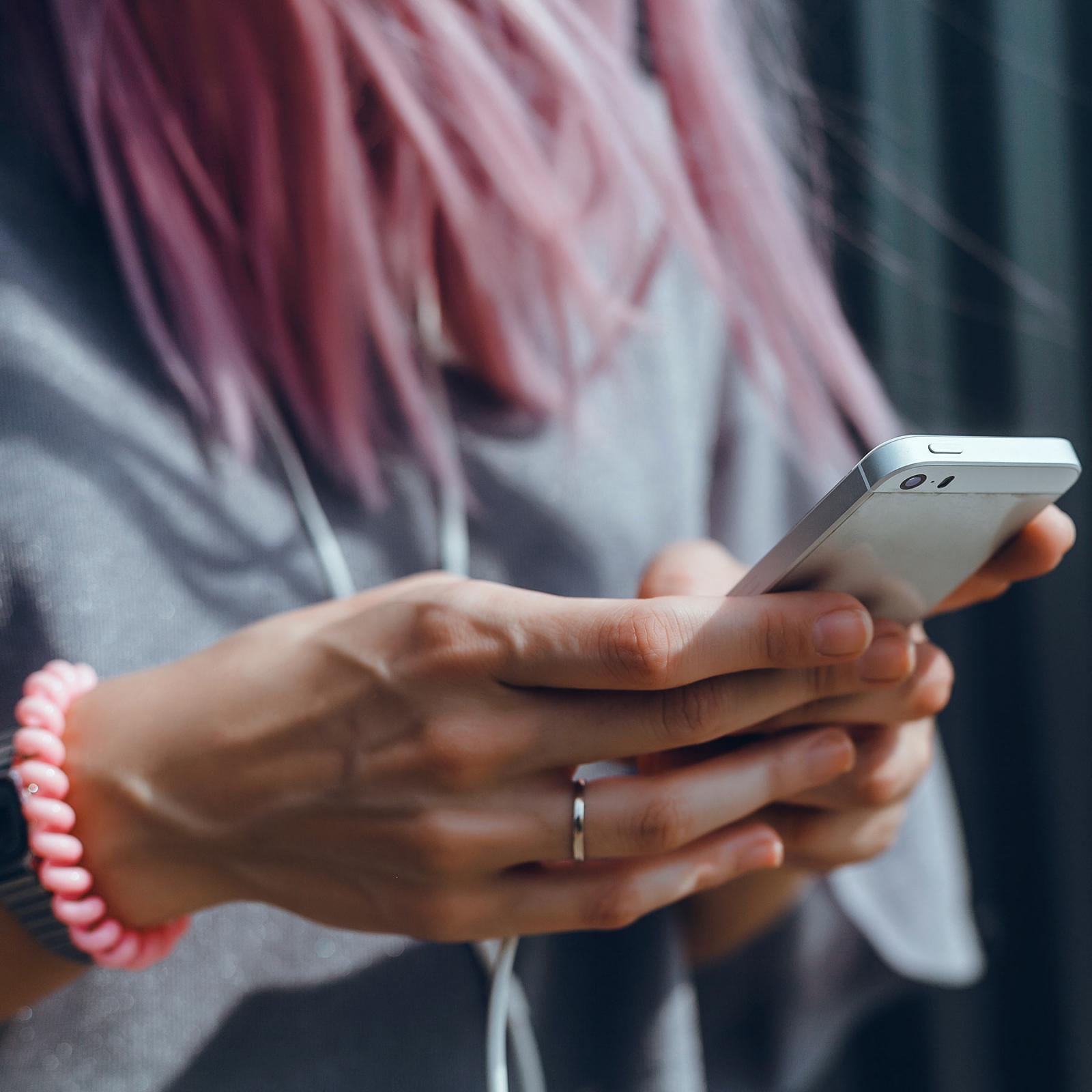 Student holding her cell phone.