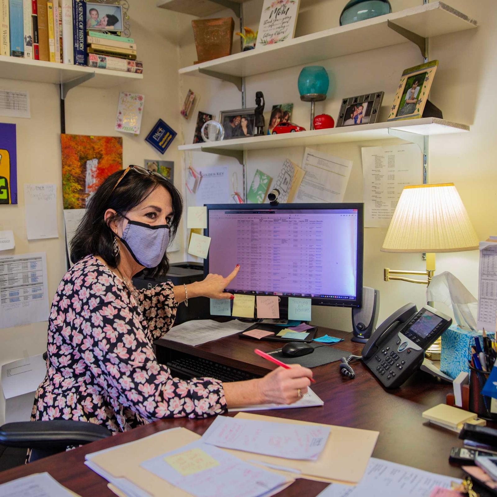 Staff member working at her desk.