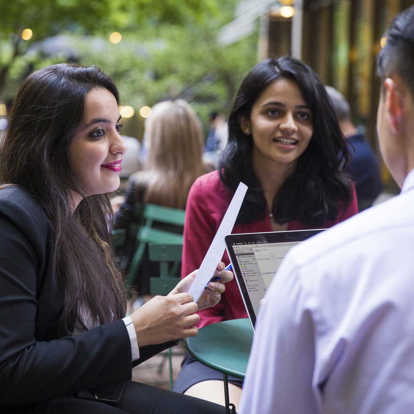 Students sitting around a table studying together.