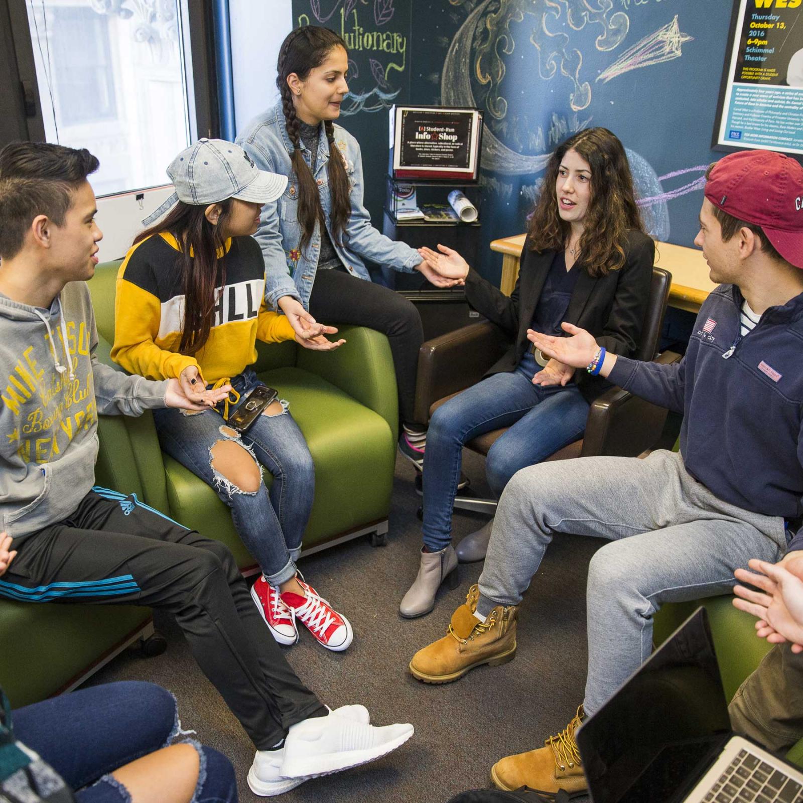 Students sitting on couches talking and laughing.