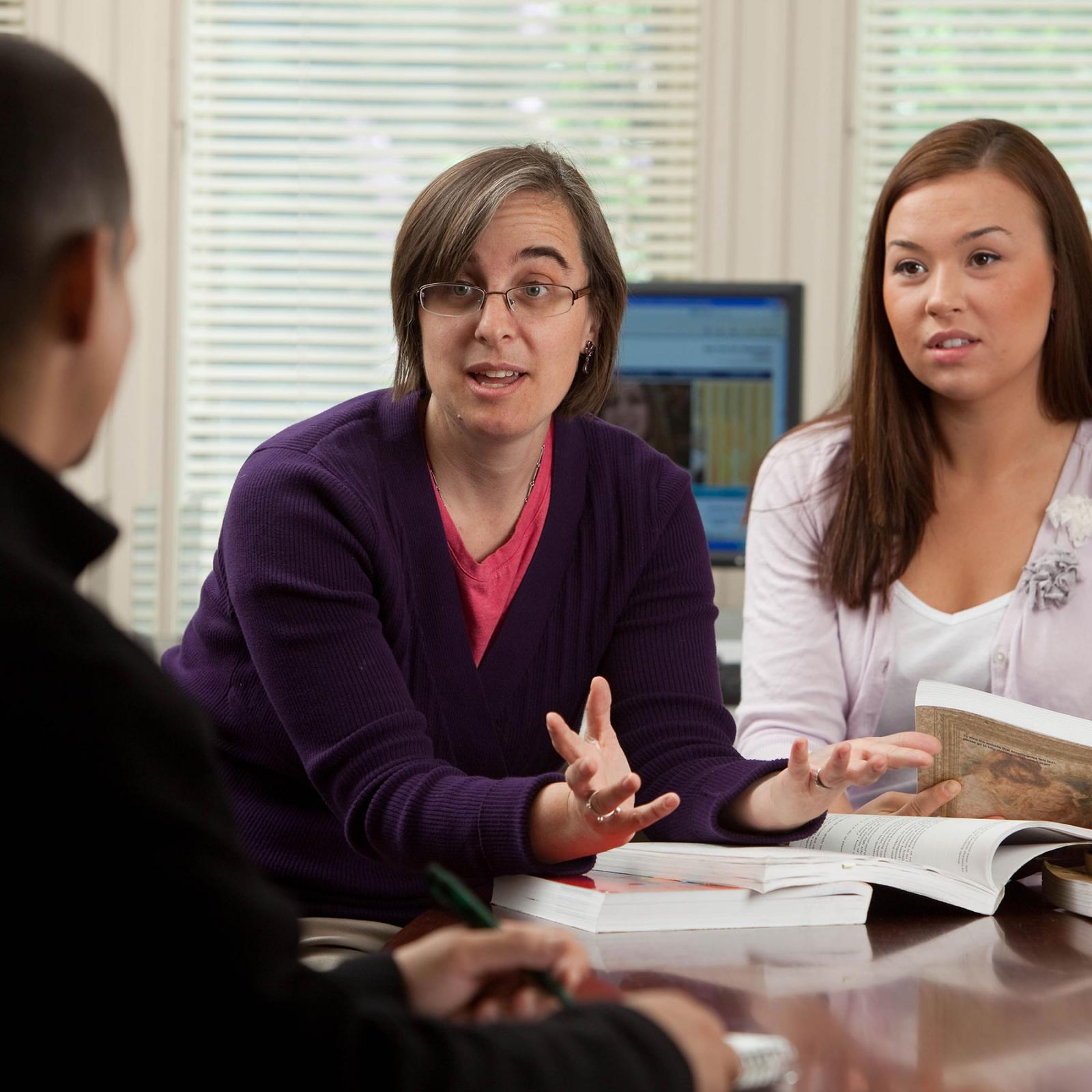 SOW faculty member teaching students in a classroom setting.