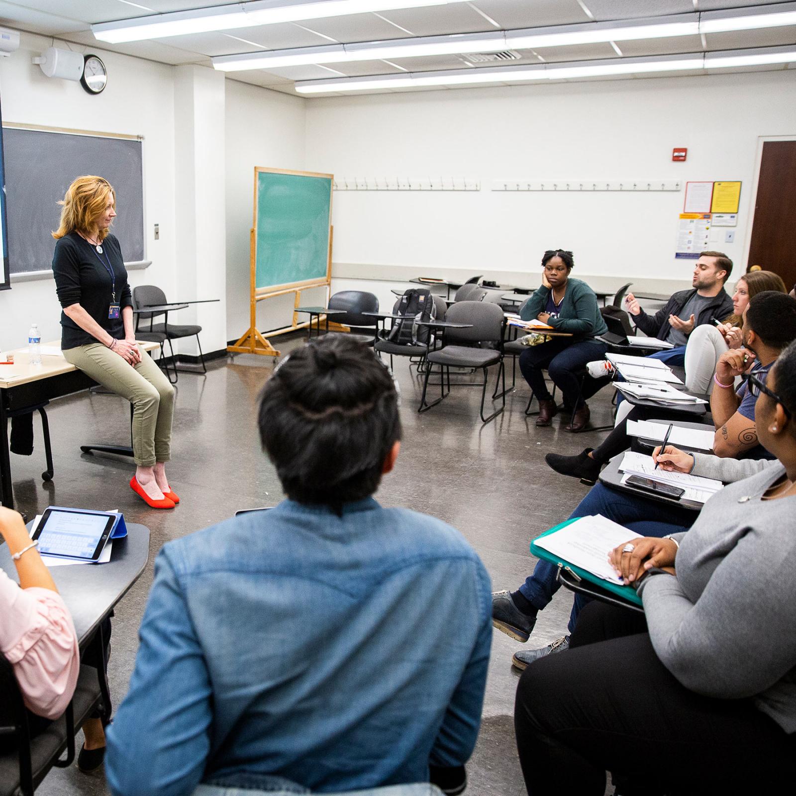 Pace students sitting in a classroom listening to a teacher.